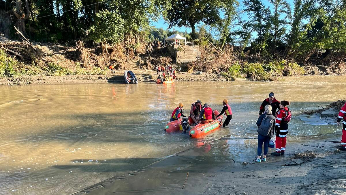 New Zealand Response Team (NZRT) members (dressed in red and black) working with Surf Lifesaving NZ volunteers to provide safe river crossings for the Rissington community
